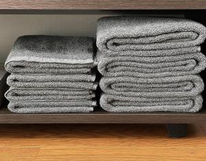 a pile of towels sitting on a shelf at ひまわり in Dazaifu