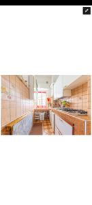 a kitchen with white counters and wooden cabinets at Casa Revello in Milan