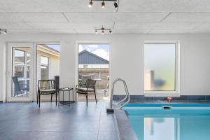 a living room with a pool and a table and chairs at bl1192-Blokhus-Holstvej-7 in Blokhus
