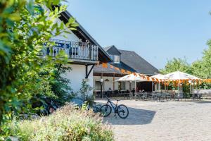 a bike parked next to a building with tables and umbrellas at Kröver Berg in Kröv