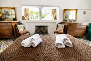 a bedroom with a bed with towels on it at Casa Colette in Anacapri +161 photos