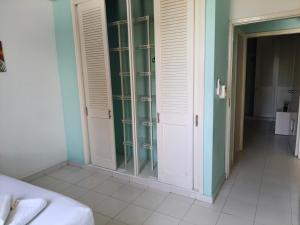 a bedroom with glass doors and a room with a bed at VILLA IRIS in Santa Marta +24 photos