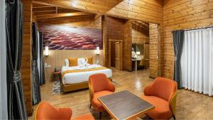 a bedroom with a bed and a table and chairs at Ridge Cabin Resort in Nairobi +35 photos