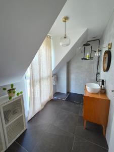 a bathroom with a sink and a staircase with a sink at Les Ganivelles in Belz