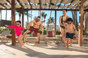 a group of people playing on the beach at Dreams Aventuras Riviera Maya - All Inclusive in Puerto Aventuras