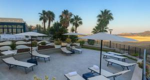 a patio with tables and chairs and umbrellas at Best Western Hotel Palace Lucera in Lucera