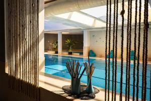 a swimming pool with vases on a table next to it at Best Western Hotel Palace Lucera in Lucera