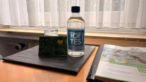a bottle of water and a book on a table at Haus Mariengrund in Münster