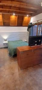a bedroom with a bed and a tv in a room at Monoambiente in Ezpeleta