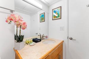 a bathroom with a sink and a mirror at Executive Center 1604 in Honolulu +10 photos