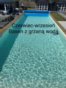 a pool of water with the words venice wimbledon bearer bearer zgra at Domki z basenem Chłapowska Przystań in Władysławowo