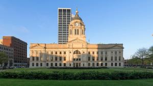 a building with a clock tower on top of it at Magnuson Hotel Fort Wayne North - Coliseum in Fort Wayne +14 photos