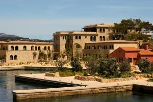 a large building next to a body of water at Zannier Île de Bendor in Bandol