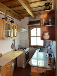 a kitchen with a stove and a sink in it at Anna Lak in Magyarszombatfa +23 photos
