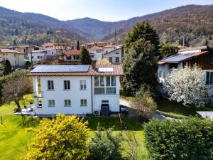 an aerial view of a white house in a village at La Casetta di Renzo e Lucia in Olginate