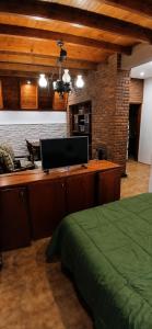 a bedroom with a desk with a computer on it at Monoambiente in Ezpeleta +4 photos