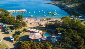 an aerial view of a beach with people in the water at Apartman Lidija in Risika