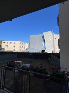 a view of a building from a balcony with flowers at Le colline in corso Bra in Alba
