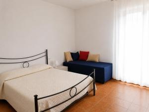 a bedroom with a bed and a couch at Via Milano 67 in Porto SantʼElpidio