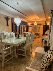 a dining room with a table and chairs and a chandelier at Fuji sleeps 16-18 in Angeles