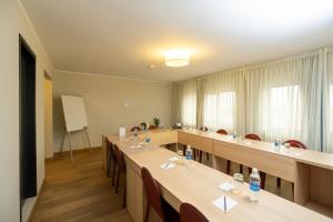 a classroom with long tables and chairs and a whiteboard at ARTE HOTEL Lima in Lima