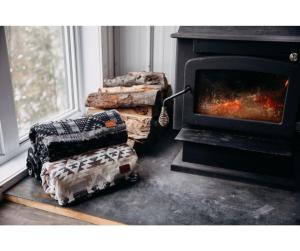 a stack of logs in front of a fireplace at TinyHouse - Touski in Val-des-Lacs