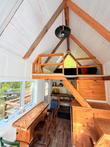 a tiny house with a loft bed and a desk at TinyHouse - Touski in Val-des-Lacs
