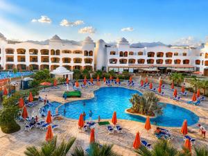 an aerial view of the resort with people sitting in chairs in a pool at Fun & Sun Naama Waves in Sharm El Sheikh
