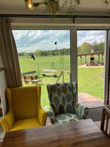 a room with a window with a chair and a table at Ubytování u Kotrbů in Suchdol nad Lužnicí