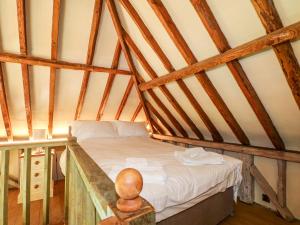 a room with a bed in a attic at Petworth Barn in Petworth +23 photos