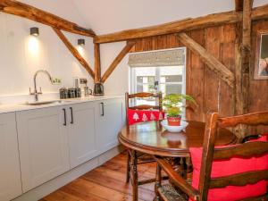 a kitchen with a table and chairs and a sink at The Granary in Petworth