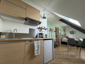 a kitchen with a sink and a counter top at Entre Terre & Sel in Clohars-Carnoët +28 photos