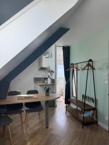a dining room with a table and chairs at Entre Terre & Sel in Clohars-Carnoët