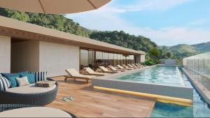 a resort with a pool and chairs and a mountain at Grand Reserva Granja Brasil in Araras Petropolis