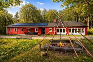 a red building with a fire in front of it at Boafall Lodge in Jämshög