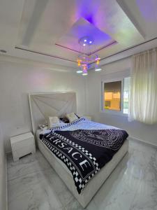 a bedroom with a bed with a purple ceiling at pacotanjawi achakar in Tangier