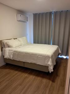 a bed in a room with a wooden floor at Grand Reserva Granja Brasil in Araras Petropolis +10 photos