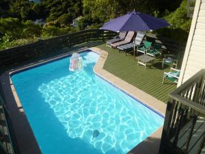 an overhead view of a swimming pool with an umbrella at Breakaway at York Bay in Days Bay
