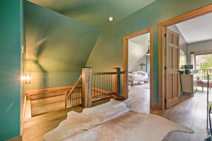 a bedroom with a green wall and a wooden staircase at Rustic Chalet & Serenity in Mont Blanc in Saint-Faustin