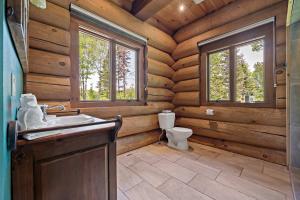 a bathroom with a toilet and a sink in a log cabin at Rustic Chalet & Serenity in Mont Blanc in Saint-Faustin +93 photos