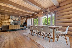 a dining room with a table and chairs at Rustic Chalet & Serenity in Mont Blanc in Saint-Faustin