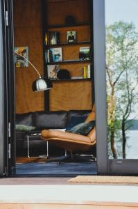 a living room with a couch and a chair at PARO cabin in Ignalina