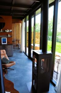 a living room with a wood stove in a room at PARO cabin in Ignalina