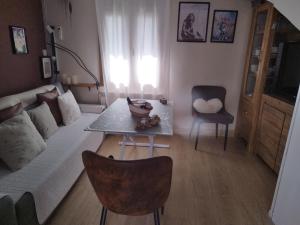 a living room with a couch and a table at CASA GORDON in Navaluenga +42 photos