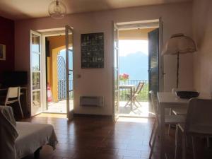 a living room with a door open to a balcony at IL BALCONE SUL LAGO in Magreglio