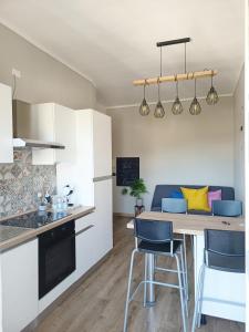 a kitchen and dining room with a table and chairs at vittorino in Turin