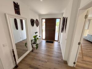 an empty hallway with a door and a potted plant at Villa Alvoria in Alvor