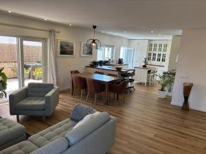 a living room with a couch and a table with chairs at Villa Alvoria in Alvor