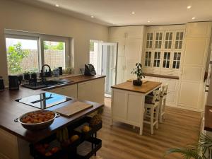 a kitchen with white cabinets and a counter top at Villa Alvoria in Alvor +35 photos