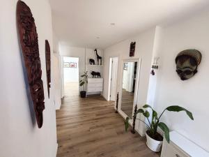a hallway of a home with white walls and wooden floors at Villa Alvoria in Alvor